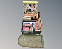 Two crates containing a large quantity of 20th century puzzles, boxed organ, board games,