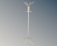 A tubular metal hat and coat stand.