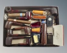 A box containing various pipes, cheroot holders, cigars and cigar cutters, Dunhill lighter etc.