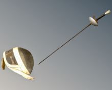 A fencing foil together with a mask.