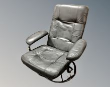 A retro style black vinyl upholstered swivel armchair on tubular metal base.