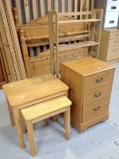 Four pine effect three drawer chests together with a nest of three tables and a set of folding