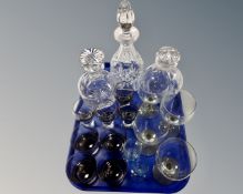 A tray of three glass decanters with stoppers, three sets of four glasses etc.