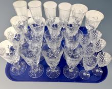 A tray of assorted drinking glasses to include a set of twelve lead crystal wine glasses