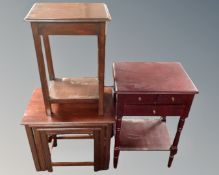 A contemporary two tier side table in a mahogany finish fitted with three drawers,