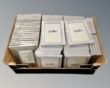 A box containing a large quantity of Xenos 13cm by 18cm silvered photo frames.