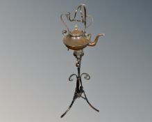 A vintage Arts & Crafts copper kettle with burner on stand