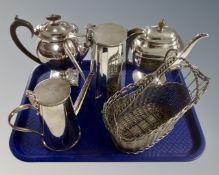 A tray containing silver plated teapots and a similar basket.