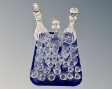 A tray containing three lead crystal decanters and further glassware including sherry glasses etc.