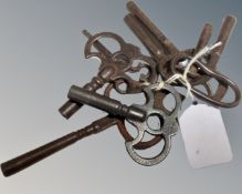 Eight antique wrought iron clock keys.