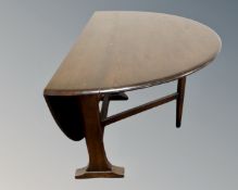 An Ercol solid elm and beech narrow drop leaf table (width 22cm) together with a set of six elm and