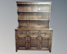 A carved oak Welsh dresser (width 140cm)