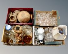 A pallet with four boxes containing glass vases, drinking vessels, wooden bowls, tea china,