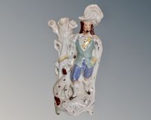 A 19th century Staffordshire figure of a gentleman and his dog.