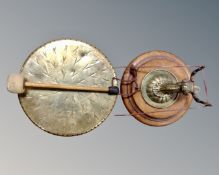 A vintage brass dinner gong with beater mounted on a brass stag's head plaque