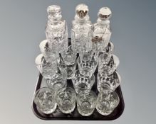 A tray containing three lead crystal decanters with stoppers and 15 further glasses.