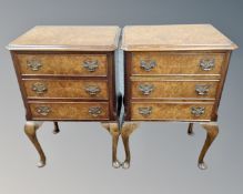 A pair of elm veneered three drawer bedside chests on cabriole legs.