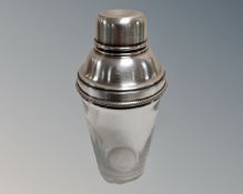 A silver plated and glass cocktail shaker.