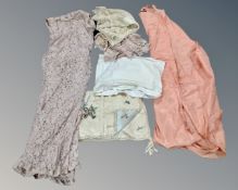 A box of early 20th century linen, wedding dress etc.