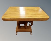 An Eastern hardwood occasional table on elephant support.