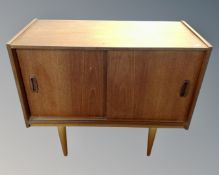 A 20th century teak sliding door record cabinet,