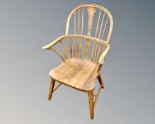 An oak Windsor style kitchen armchair.