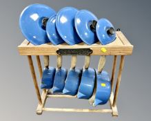 A set of five French Le Creuset enamelled cast iron cooking pans with lids on Le Creuset pine pan