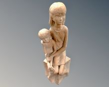 A pottery figure of a seated girl and boy.