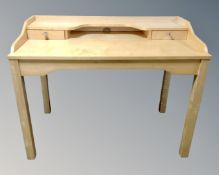 A contemporary computer desk in pine finish.