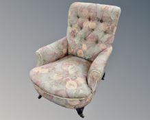 A late Victorian armchair in buttoned floral upholstery.