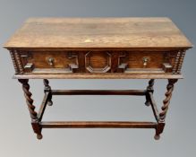 An Edwardian oak hall table fitted with a drawer, on barleytwist support.