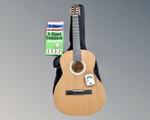 A Czech Strunal classical guitar in soft carry bag with guitar tuner and guitar books and