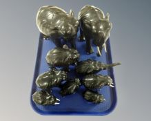 A tray of nine carved ebonized figures of elephants.