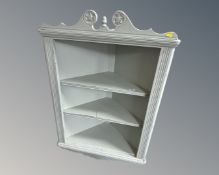 A painted hanging corner cabinet.