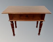 A contemporary hardwood hall table fitted with a drawer.