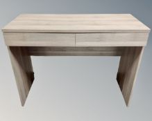 A contemporary desk fitted with a drawer.