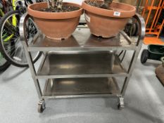 A stainless steel commercial three tier trolley