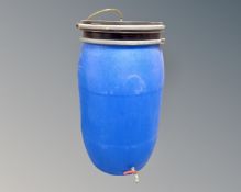 A plastic brewing barrel with tap.