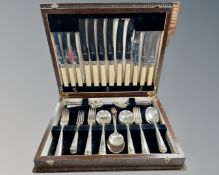 An early 20th century oak canteen of stainless steel cutlery.