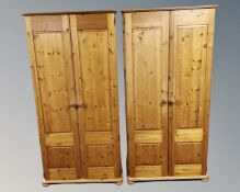 A pair of contemporary pine double door wardrobes