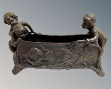 A cast bronze planter surmounted by cherubs.