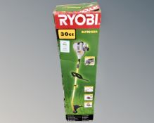 A boxed Ryobi 30cc petrol strimmer.