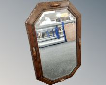 An Edwardian carved oak octagonal mirror.