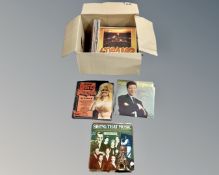 A box containing vinyl LP records and box sets including Dolly Parton, James Galway,