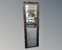 A contemporary hall mirror in a bronze finish.