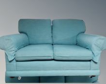 A two seater settee in light blue upholstery,