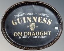 A Guinness on draught advertising tray.