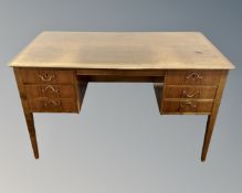 A continental walnut writing desk fitted with six drawers,