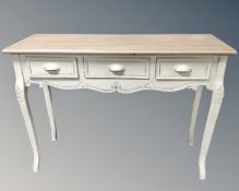 A French style hall table fitted with three drawers.