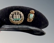 A military cap with Northamptonshire badge and one further cap badge.
